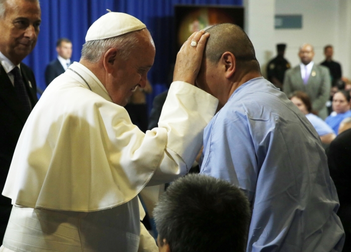 Pope Francis blesses an inmate as he meets with prisoners at Curran-Fromhold Correctional Facility in Philadelphia.