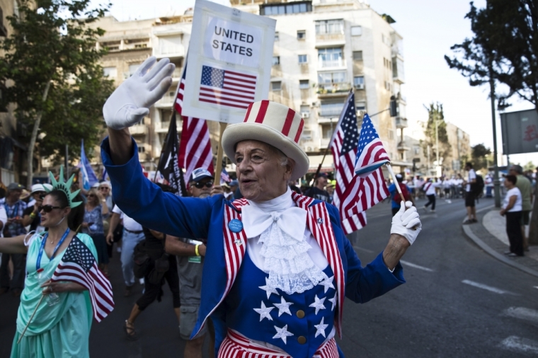 A participant waves an American flag during an annual parade on the Jewish holiday of Sukkot in Jerusalem, Israel, October 1, 2015. Thousands of foreigners who support Israel took part on Thursday in the parade along with groups of Israelis.