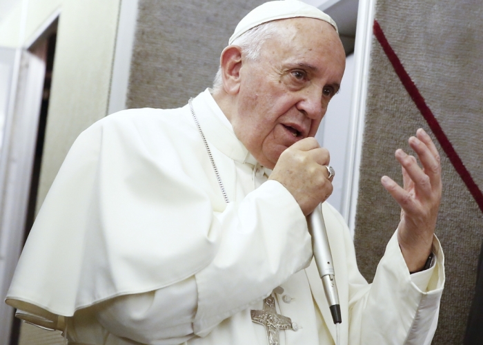 Pope Francis talks aboard the papal plane while en route to Italy September 28, 2015. The pope left the United States on Sunday night, departing from Philadelphia International Airport on an American Airlines flight to Rome.