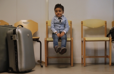 A young boy reacts moments after refugees from Syria and Irak arrived at a refugee centre in Champagne-sur-Seine, near Paris, France, September 9, 2015. France is ready to take in 24,000 refugees as part of European Union plans to welcome more than 100,000 in the next two years, the French President said on Monday, dismissing opinion polls showing public opposition to the move.