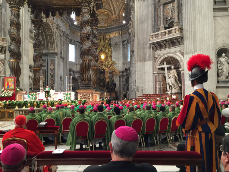 More than 300 delegates of the Vatican Synod on Family wearing green robes listen to Pope Francis preach in St. Peter's Church on Sunday, October 4, 2015.