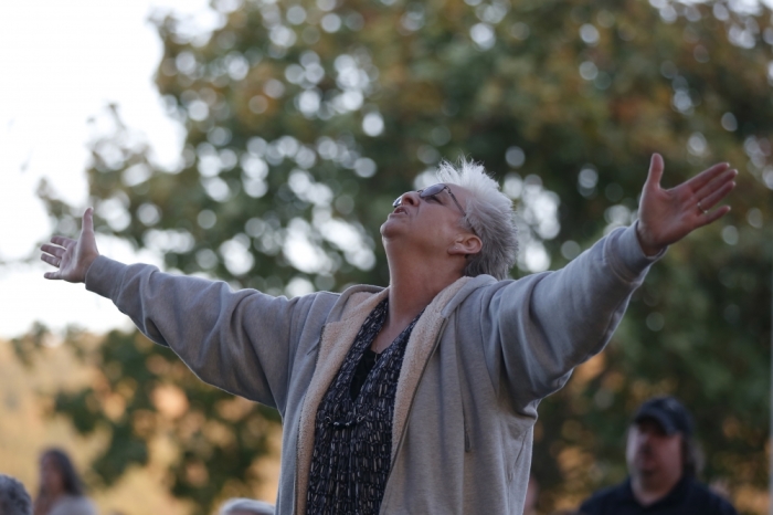 A woman prays during a candlelight vigil for victims of the Umpqua Community College shooting, in Winston, Oregon, United States, October 3, 2015. The gunman who killed his English professor and eight others at an Oregon community college committed suicide after a shootout with police who were on the scene within five minutes and exchanged fire with him almost immediately, authorities said.