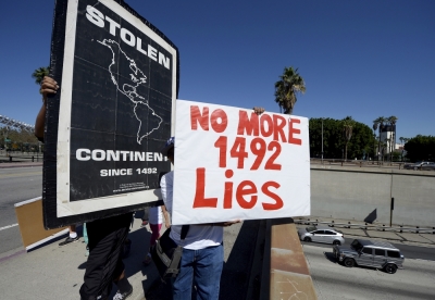 Members and supporters of the Mexica Movement organization march across the overpass of Hollywood Freeway as they protest against Columbus Day in downtown Los Angeles, California, October 11, 2015. The group was protesting what they call criminal actions by Christopher Columbus against Native Americans.