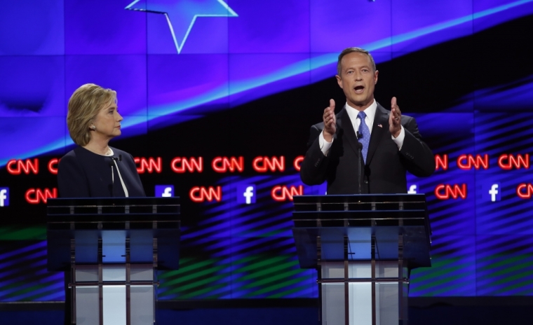 U.S. Democratic presidential candidate and former Secretary of State Hillary Clinton listens as former Maryland Governor Martin O'Malley speaks during the first official Democratic candidates debate of the 2016 presidential campaign in Las Vegas, Nevada, October 13, 2015.