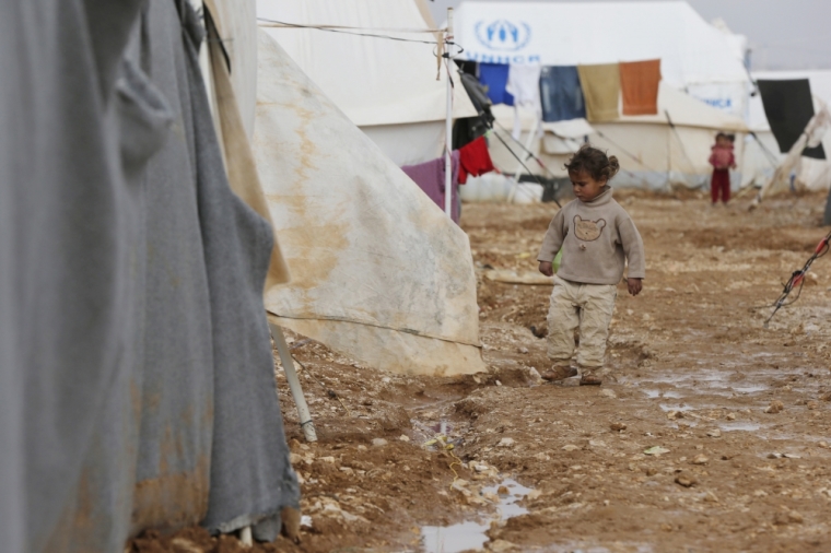 A Syrian refugee girl walks near her family tent after the U.N. High Commissioner for Refugees Antonio Guterres visited Al Zaatari refugee camp in the Jordanian city of Mafraq, near the border with Syria, January 15, 2015. Syrian refugees in Jordan's main Zaatari refugee camp appealed for help during the last week after a storm buffeted the Middle East region with blizzards, rain and strong winds.