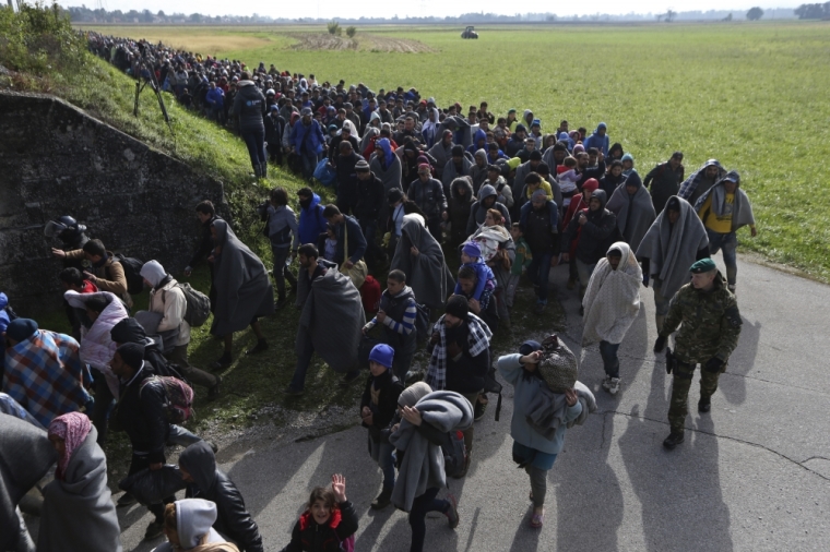 A group of migrants continue their journey near Dobova, Slovenia October 20, 2015. Migrants continue to stream north through the Balkans from Greece but Hungary sealed its border with Croatia on Friday and Slovenia imposed daily limits on migrants entering from Croatia, leaving thousands stuck on cold, rain-sodden frontiers.