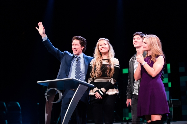 Pastor Joel Osteen is joined on stage by his wife, Victoria, and children, Alexandra and Jonathan, during the afternoon session of Night of Hope at the Barclays Center in Brooklyn, New York on October 16, 2015.