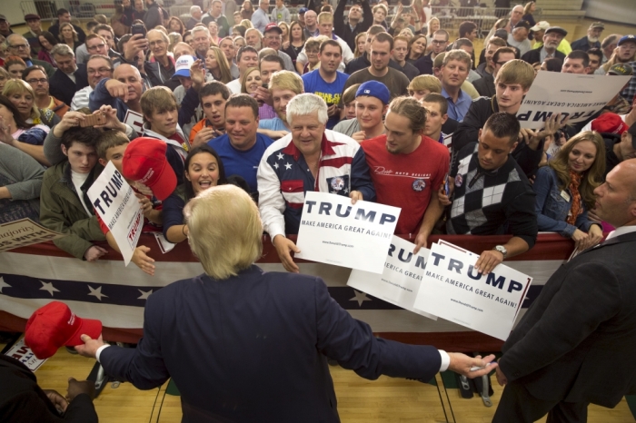 Republican U.S. presidential candidate Donald Trump greets supporters after speaking at a campaign rally at West High School in Sioux City, Iowa, October 27, 2015.