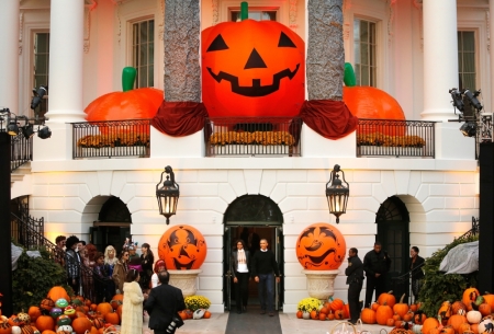 U.S. President Barack Obama and first lady Michelle Obama walk out to greet children on the South Lawn for a Halloween trick-or-treating celebration in Washington October 31, 2014. Invitees included local children and the children of military families, according to the White House.