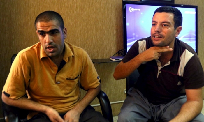 Mohammed Abd Ahmed (R) and Ahmed Mahmoud Mustafa, two of the 69 hostages rescued from an Islamic State prison in a joint raid by U.S. and Kurdish special forces, attend an interview with Reuters in Erbil, Iraq, October 29, 2015.