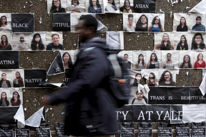 A student walks by a college notice board on campus at Yale University in New Haven, Connecticut November 12, 2015. More than 1,000 students, professors and staff at Yale University gathered on Wednesday to discuss race and diversity at the elite Ivy League school, amid a wave of demonstrations at U.S. colleges over the treatment of minority students.