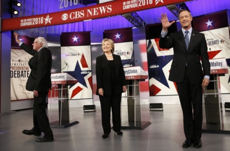 Democratic U.S. presidential candidates Senator Bernie Sanders (L), former Secretary of State Hillary Clinton and former Maryland Governor Martin O'Malley pose on stage ahead of the second official 2016 U.S. Democratic presidential candidates debate in Des Moines, Iowa, November 14, 2015.