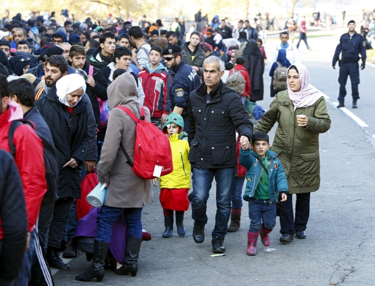 Syrian migrants Zake Khalil (3rdR), his wife Nagwa (R) and their four children Joan, Torin, Ellen and newborn Hevin arrive at the Austrian-German border in Achleiten near Passau, Germany, October 27, 2015. The premier of the state of Bavaria Premier Horst Seehofer criticised Austria on Tuesday for failing to coordinate the flow of migrants into southern Germany even as he renewed a challenge to Chancellor Angela Merkel over her management of the refugee crisis. Germany is taking in more migrants than any other EU state. It expects 800,000 to 1 million people, many from war zones in the Middle East, Africa and Afghanistan, to arrive this year.