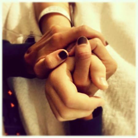 An apparent photo of Amber Byars Wilkinson holding the hand of her sister Amanda Blackburn on a hospital bed. Amanda was the wife of Resonate Church pastor Davey Blackburn in Indianapolis, Indiana. She was fatally shot in the head on November 10, 2015 during what police theorize was a home invasion.