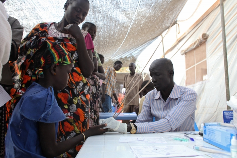 A displaced girl is tested for malaria at an MSF clinic in Tomping camp, where some 17,000 displaced people who fled their homes are being sheltered by the United Nations, in Juba, January 10, 2014. Violence erupted in South Sudan's capital Juba in mid-December and spread to oil-producing regions and beyond, dividing the two-year-old land-locked country along ethnic lines. Some 60,000 civilians are being protected at U.N. Bases.