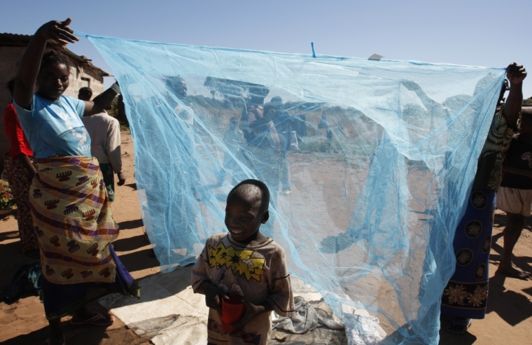 Zambian villagers display a mosquito net offered by the Roll Back Malaria Zambezi Expedition in Matongo village, about 60 km (37 miles) from Livingstone, April 23, 2008. Zambia will host the World Malaria Day in the presence of Belgium's Princess Astrid, Goodwill Ambassador of the Roll Back Malaria Partnership on April 25. The medical teams of the expedition will travel more than 2,500 km (1,553 miles) in inflatable boats through Angola, Namibia, Botswana, Zambia, Zimbabwe to deliver mosquito nets and medications to remote areas.