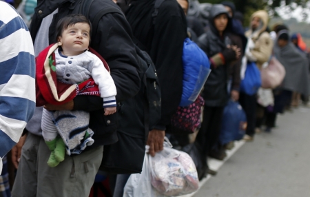 Migrants continue their journey after crossing the border from Serbia in Bapska, Croatia, October 20, 2015.