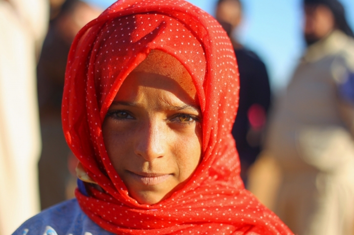 An internally displaced girl poses at a makeshift refugee camp in Sinjar town, in Idlib province, Syria November 20, 2015.