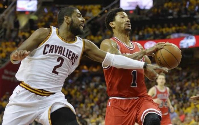 Kyrie Irving (2) defends Bulls guard Derrick Rose (1).