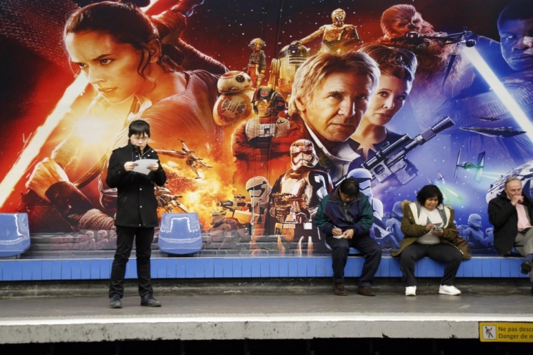 People wait into a metro station decorated with Star Wars characters to promote the upcoming film 'Star Wars: The Force Awakens' in Paris, France, December 1, 2015. The movie will be released on Dec. 16 in Paris, two days before its worlwide official release.