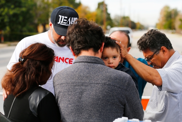 Neighbours comfort a family who were prevented by police from returning to their home near the scene of the investigation of an SUV where two suspects were shot by police following a mass shooting in San Bernardino, California, December 3, 2015. Authorities on Thursday were working to determine why Syed Rizwan Farook 28, and Tashfeen Malik, 27, opened fire at a holiday party of his co-workers in Southern California, killing 14 people and wounding 17 in an attack that appeared to have been planned.