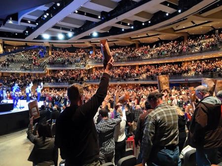 Volunteers at Willow Creek Community Church of South Barrington, Illinois, hold up care packages made for prisoners for Christmas, Dec. 6, 2015.