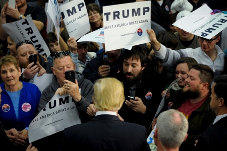 U.S. Republican presidential candidate Donald Trump greets supporters and signs autographs after a campaign stop in Spencer, Iowa December 5, 2015.