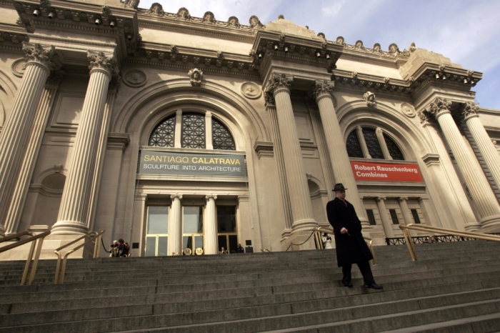 A visitor walks down the steps of the Metropolitan Museum of Art in New York, March 6, 2006. The Metropolitan held a ceremony to dedicate its newly renovated facade after a four year .2 million restoration of the 104-year-old limestone building.