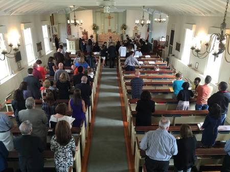 Congregants of Christ Episcopal Church stand inside the sanctuary during a service in this undated photo.