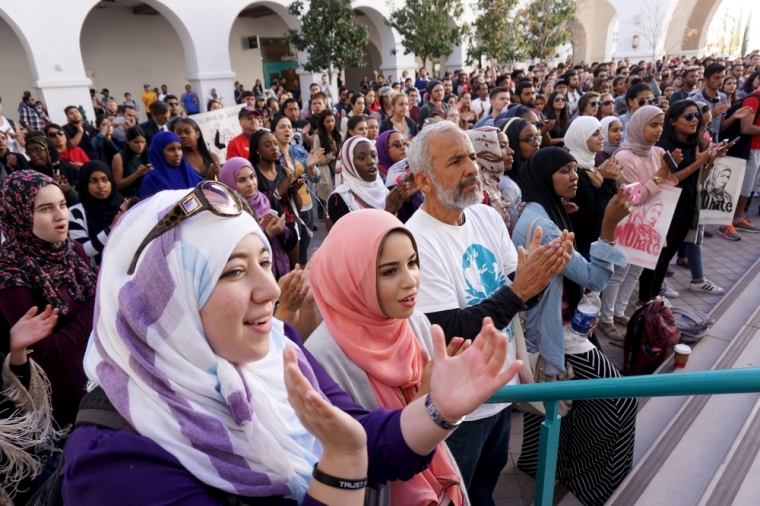 Students and supporters applaud at a rally against Islamophobia at San Diego State University in San Diego, California, November 23, 2015.