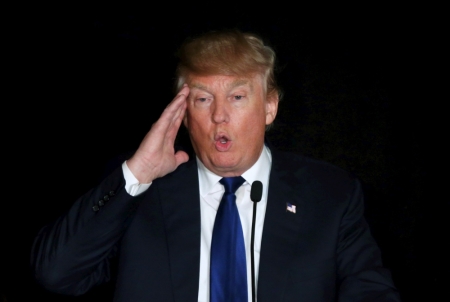 U.S. Republican presidential candidate Donald Trump gestures as he speaks at the meeting of the New England Police Benevolent Association in Portsmouth, New Hampshire December 10, 2015.