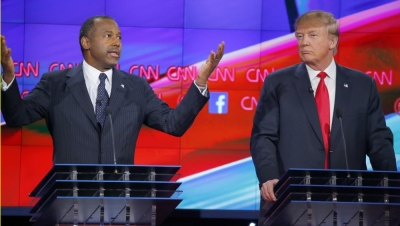 Republican U.S. presidential candidate Dr Ben Carson (L) speaks as businessman Donald Trump (R) listens during the Republican presidential debate in Las Vegas, Nevada December 15, 2015.