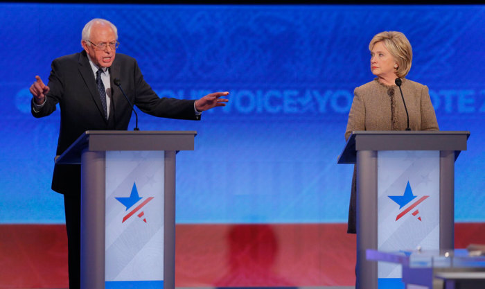 Democratic U.S. presidential candidate Senator Bernie Sanders answers a question as rival candidate and former U.S. Secretary of State Hillary Clinton listens at the Democratic presidential candidates debate at St. Anselm College in Manchester, New Hampshire December 19, 2015.