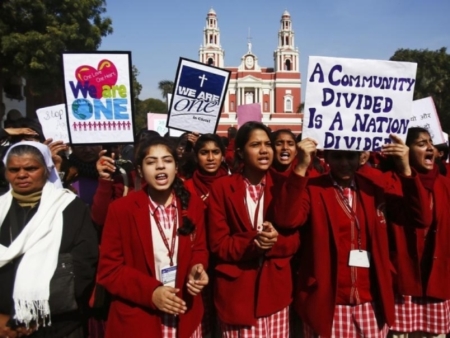 Demonstrators shout slogans as they hold placards during a protest outside a church in New Delhi February 5, 2015.