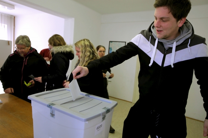 A man casts a ballot at the polling station during a referendum on whether to give same-sex couples the right to marry and to adopt children, in Naklo, Slovenia, December 20, 2015.