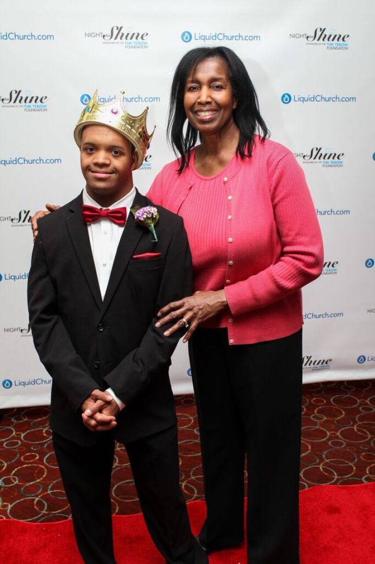 A guest and 'buddy' pose for cameras on the red carpet at the Night to Shine prom event co-hosted by Liquid Church and sponsored by the Tim Tebow Foundation, Morristown, New Jersey, February 13, 2015.