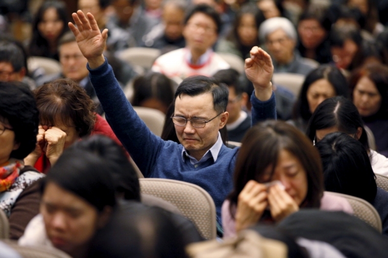 Jae Sun Lee of North York raises his hands while praying for Canadian Pastor Hyeon Soo Lim who is being held in North Korea during a joint multi-cultural prayer meeting at Light Korean Presbyterian Church in Toronto, December 20, 2015. Canadian diplomats were allowed to meet detained pastor Lim on Friday, after he was sentenced to life in prison in North Korea earlier last week, and found him in good spirits and health, a church spokeswoman said on Sunday.