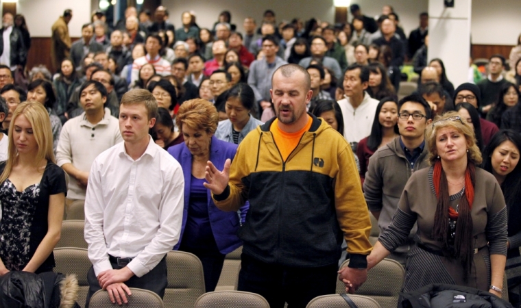 (Front row L-R) Yekaterina Zhilyayev, Boris Melikov, Vladislav Zhilyayev and Tatiana Zhilyayev pray for Canadian Pastor Hyeon Soo Lim who is being held in North Korea during a joint multi-cultural prayer meeting at Light Korean Presbyterian Church in Toronto, December 20, 2015. Canadian diplomats were allowed to meet detained pastor Lim on Friday, after he was sentenced to life in prison in North Korea earlier last week, and found him in good spirits and health, a church spokeswoman said on Sunday.