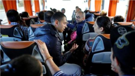 Christian Syrian refugees travel in a bus which transports fifteen members of the same family who arrived at the Charles-de-Gaulle International Airport in Roissy, October 2, 2015.