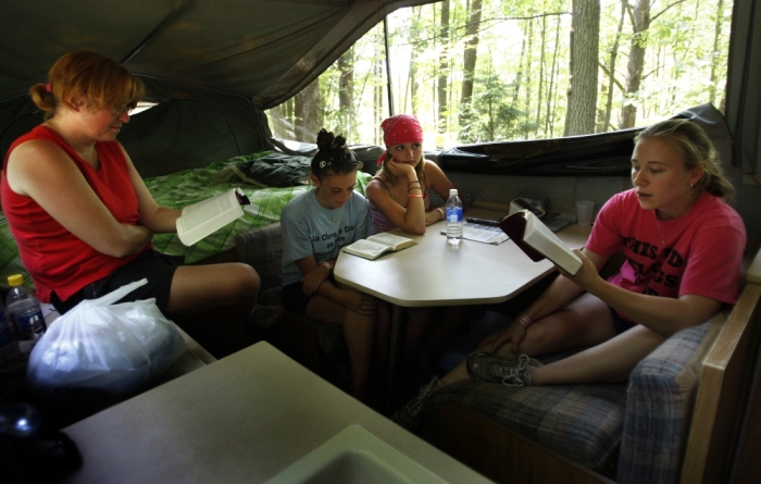 The Frank family of Dover Deleware reads the Bible together in their camper trailer during the Creation Christian music festival near Mount Union, Pennsylvania, June 28, 2008. Around 70,000 people attended Creation, a festival now in its 30th year which features some of the biggest names in Christian music. The festival draws individuals, Church youth groups and families, many of whom spend four days camping at the farm in rural Pennsylvania where the festival is held.