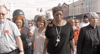 L-R: Alveda King, Charmaine Yoest and Catherine Davis march across the bridge in Selma, Alabama