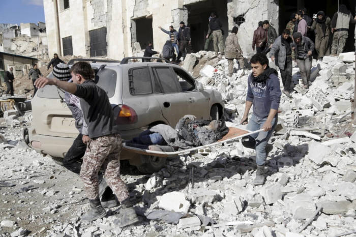 Residents carry an injured woman on a stretcher in a site hit by what activists said were airstrikes carried out by the Russian air force in the rebel-controlled area of Maaret al-Numan town in Idlib province, Syria January 9, 2016. At least 70 people died in what activists said where 4 vacuum bombs dropped by the Russian air force in the town of Maaret al-Numan; other air strikes were also carried out in the towns of Saraqib, Khan Sheikhoun and Maar Dabseh, in Idlib.