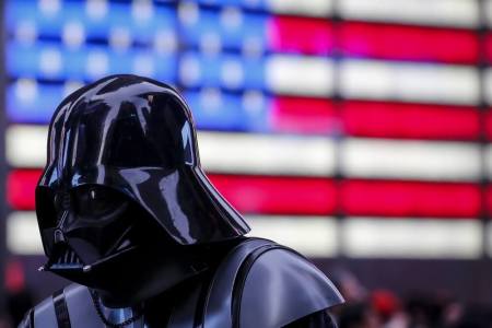 A man dressed as Darth Vader from Star Wars walks though Times Square during unseasonably warm weather on Christmas eve in the Manhattan borough of New York, December 24, 2015.