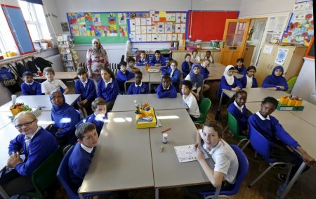 Pupils pose for a photograph in Ms. Yasmin Hussain's year 6 class at Salusbury Primary School in London, Britain, June 25, 2015.