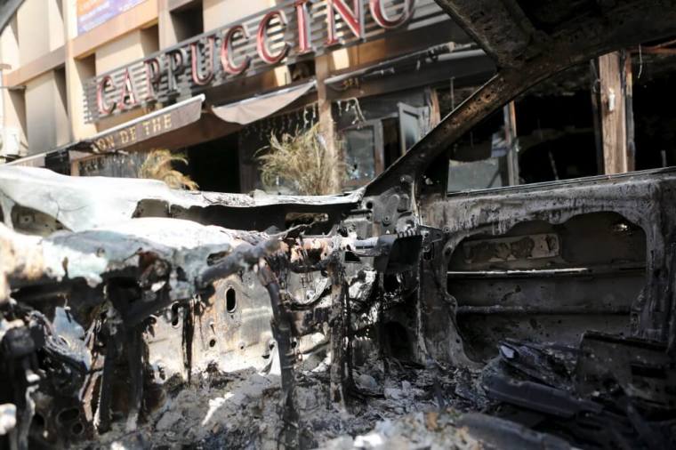 The front of Cappuccino restaurant is seen from a burned-out car after an attack on the restaurant and the Splendid Hotel, in Ouagadougou, Burkina Faso, January 18, 2016.