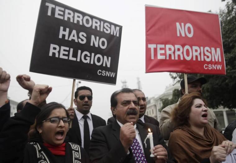 People chant slogans as they hold signs to condemn the militant attack at Bacha Khan University in Charsadda, during a protest in Lahore, Pakistan, January 20, 2016.