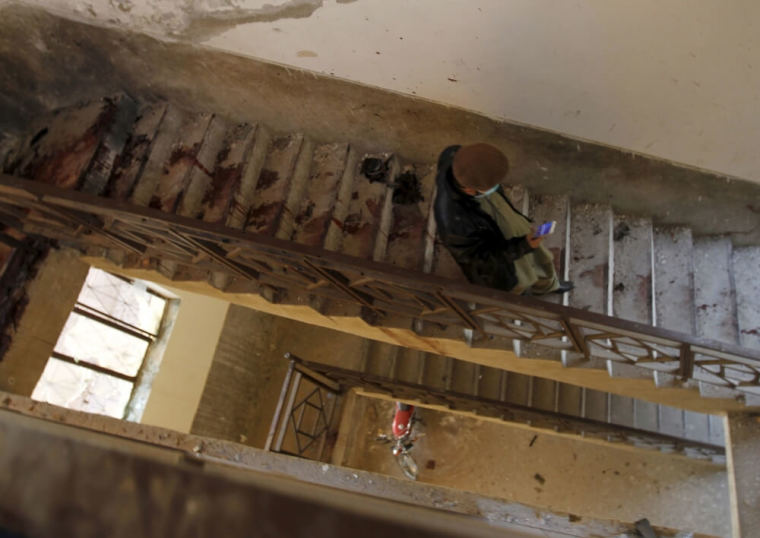 A man walks down the blood-stained stairs leading down from the roof of a dormitory where a militant attack took place, at Bacha Khan University in Charsadda, Pakistan, January 20, 2016.