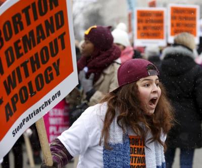 A pro-abortion activist yells at pro-life supporters (not pictured) in front of the Supreme Court during the National March for Life rally in Washington January 22, 2016. The rally marks the 43rd anniversary of the U.S. Supreme Court's 1973 abortion ruling in Roe v. Wade.