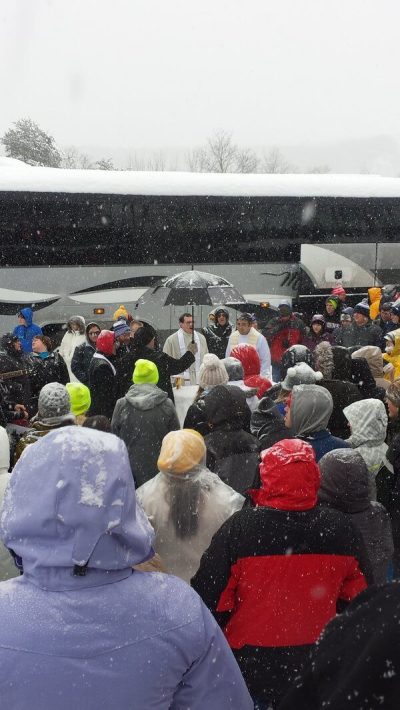 Catholic pro-life group whose bus was stuck on the Pennsylvania Turnpike on Saturday, Jan. 23, 2016, after participating in the March for Life annual event in Washington, D.C., on Friday, hold an impromptu mass using snow altar.