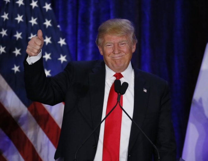 Republican U.S. presidential candidate Donald Trump gives a thumbs up gesture at his caucus night rally in Des Moines, Iowa February 1, 2016.